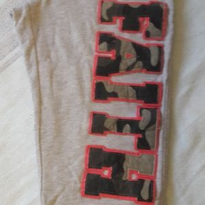 Grey sweatpants with "Faith" written across leg.